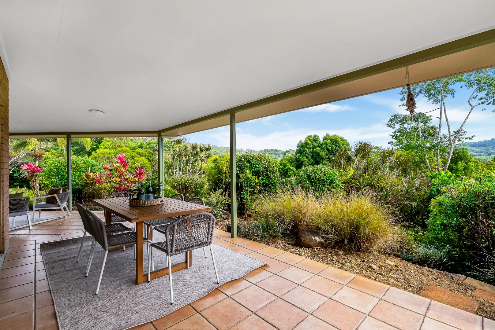 Covered patio facing established tropical garden