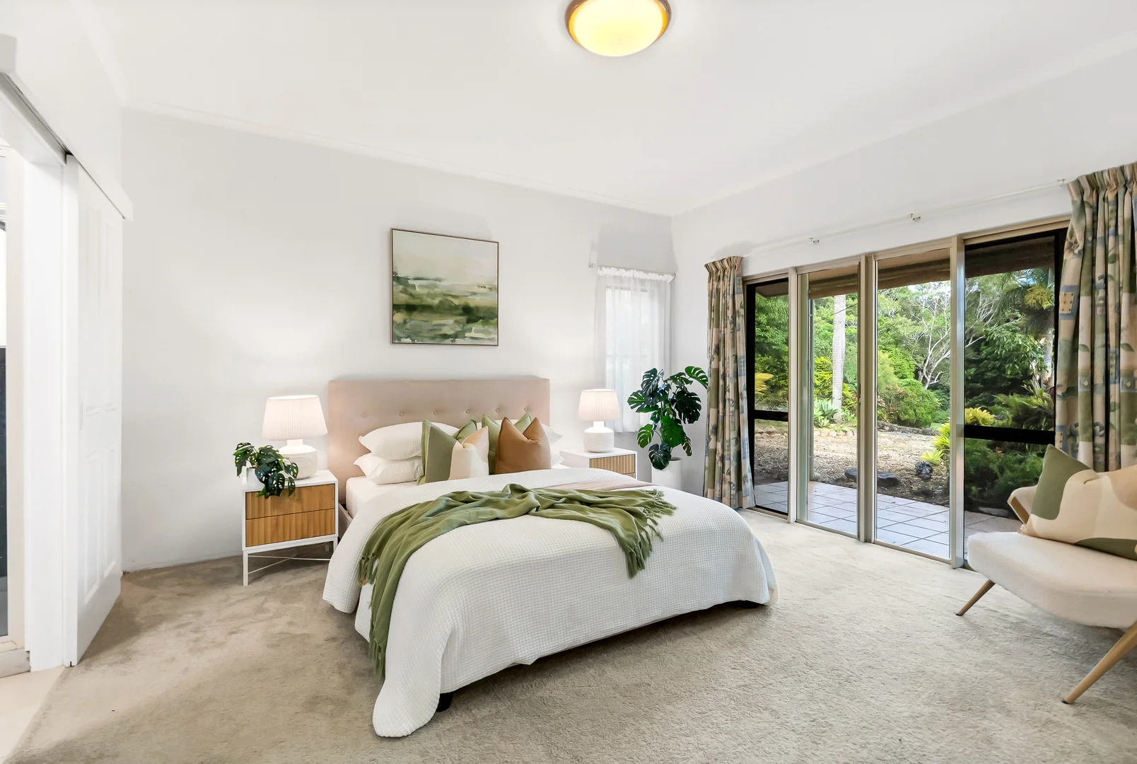 Bright main bedroom opening toward the garden